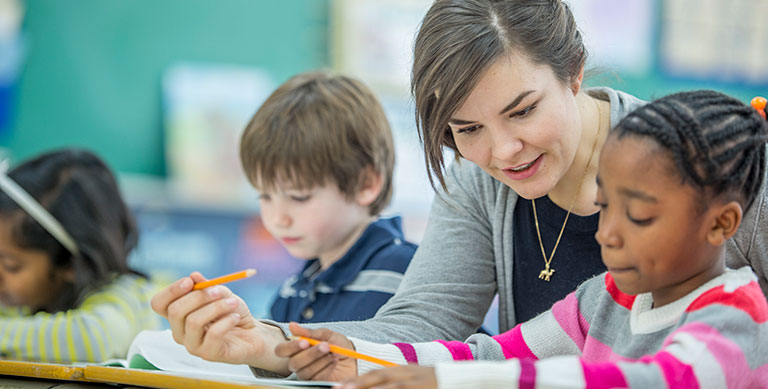 teacher helping student work