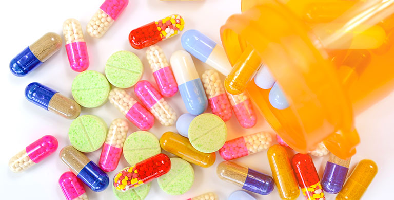 Medication capsules in orange bottle